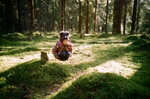 child squatting outdoors