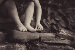 child barefoot outdoors