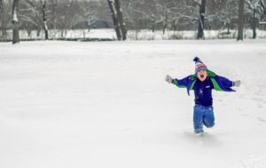 child playing in the snow